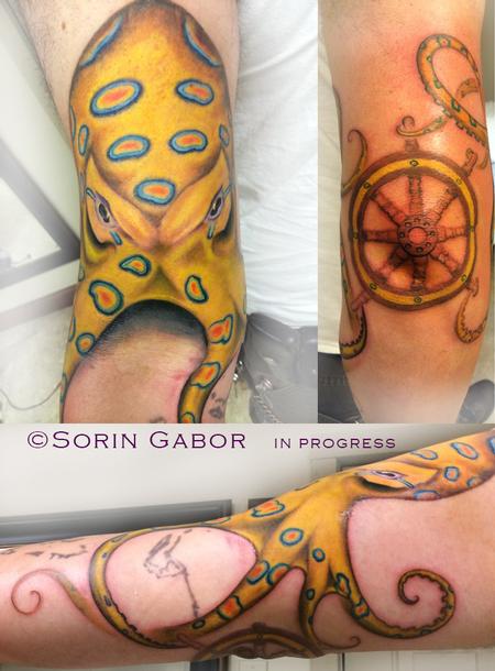 Sorin Gabor - Realistic color blue ring octopus tattoo with ship wheel